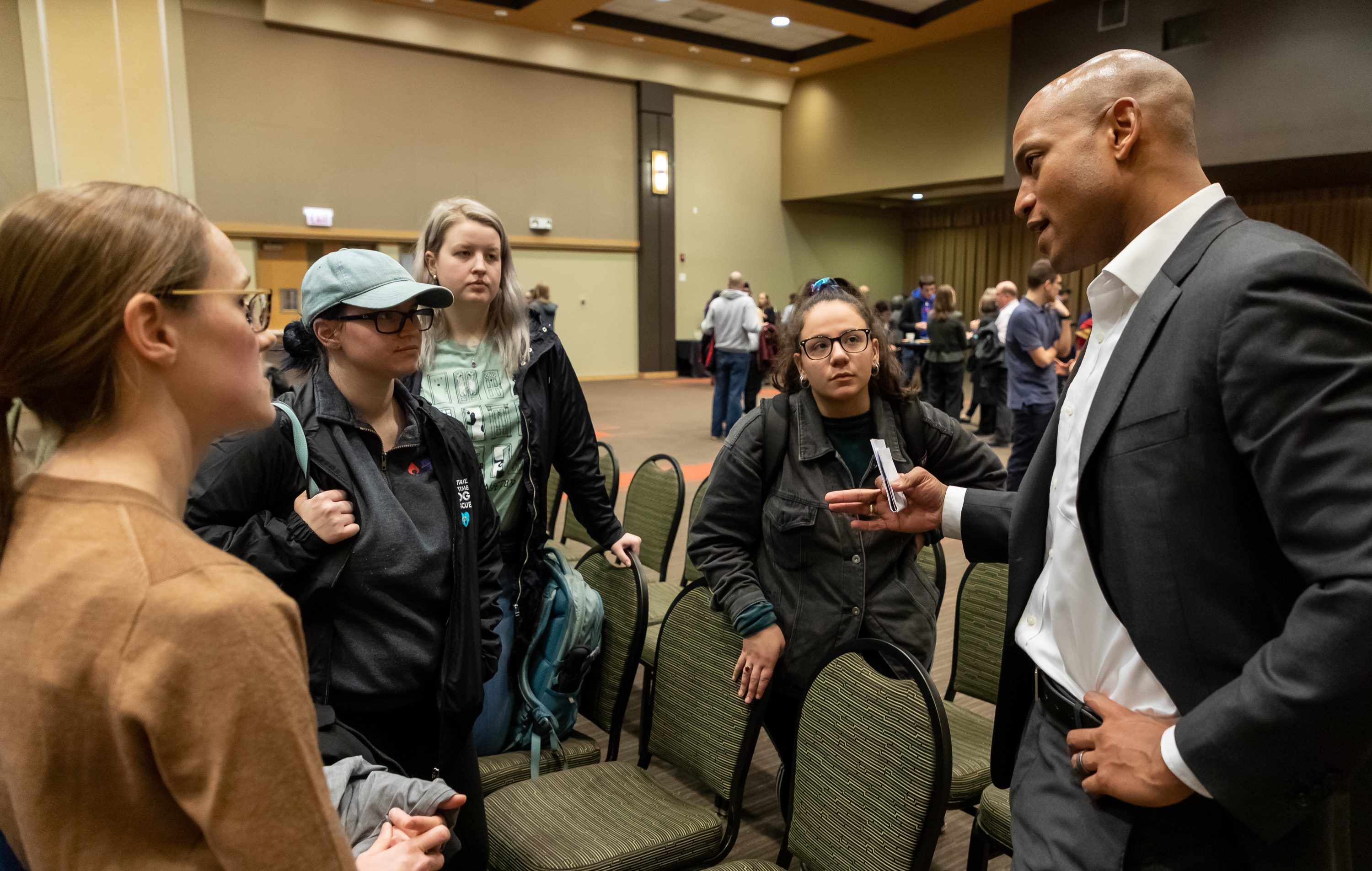 Wes Moore talks with students who attended the presentation during a reception after the event. (DePaul University/Jeff Carrion)